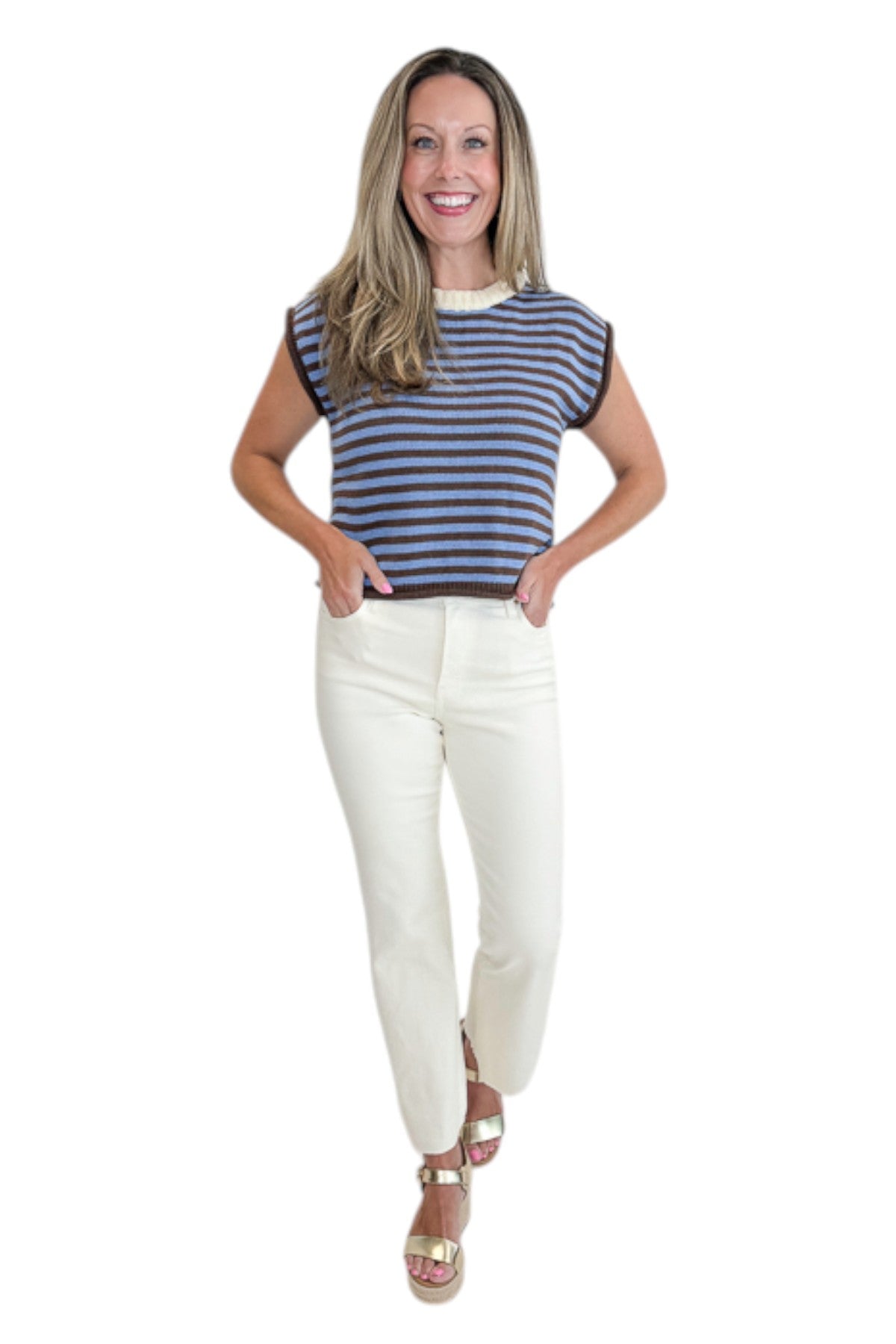 Front view of woman wearing Swagger Boutique’s Brown &amp; Blue Striped Sleeveless Sweater by Entro with jeans against white studio background.