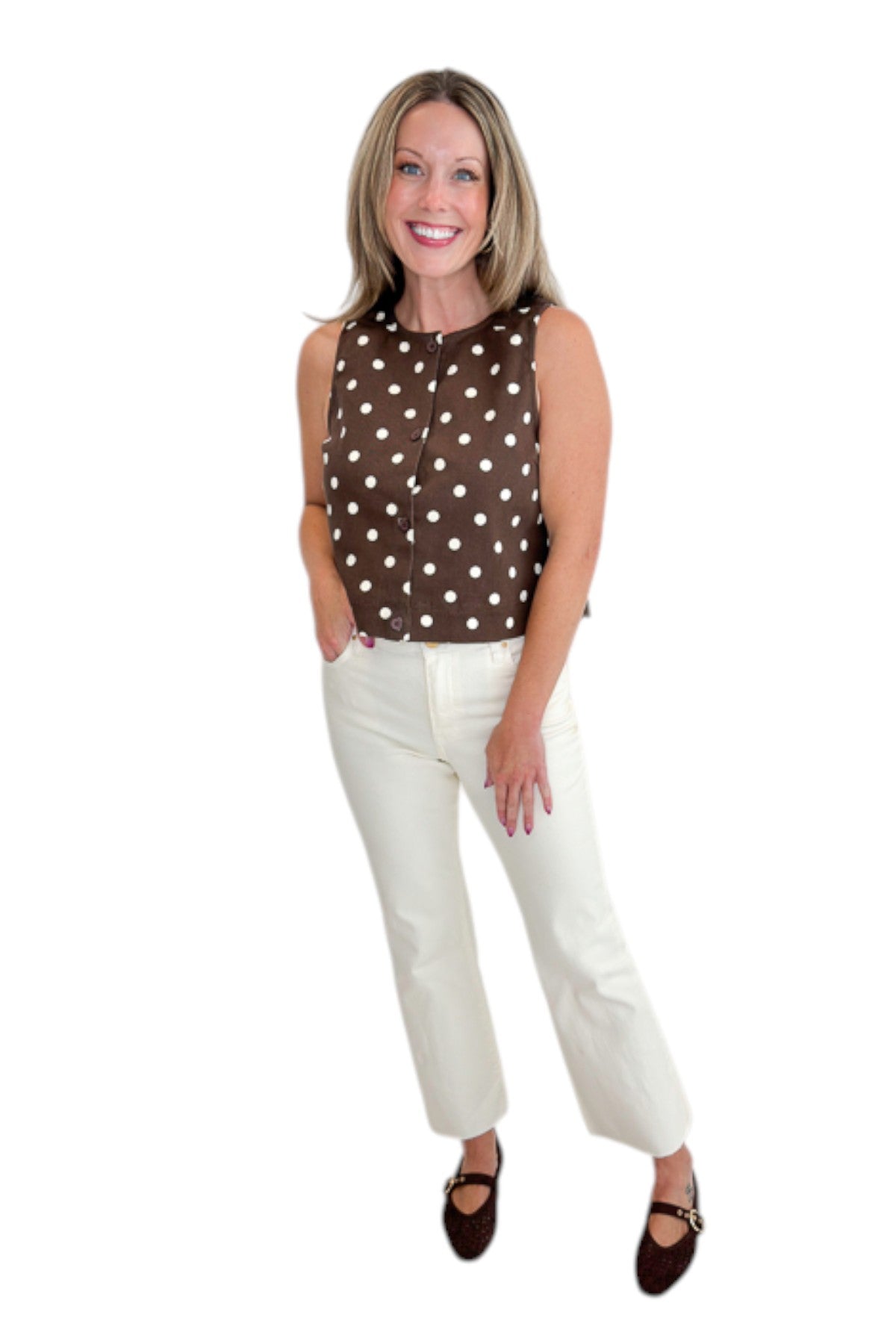 Front view of woman wearing Swagger Boutique’s Brown &amp; Cream Polka Dot Button Up Tank by Entro with jeans against white studio background.