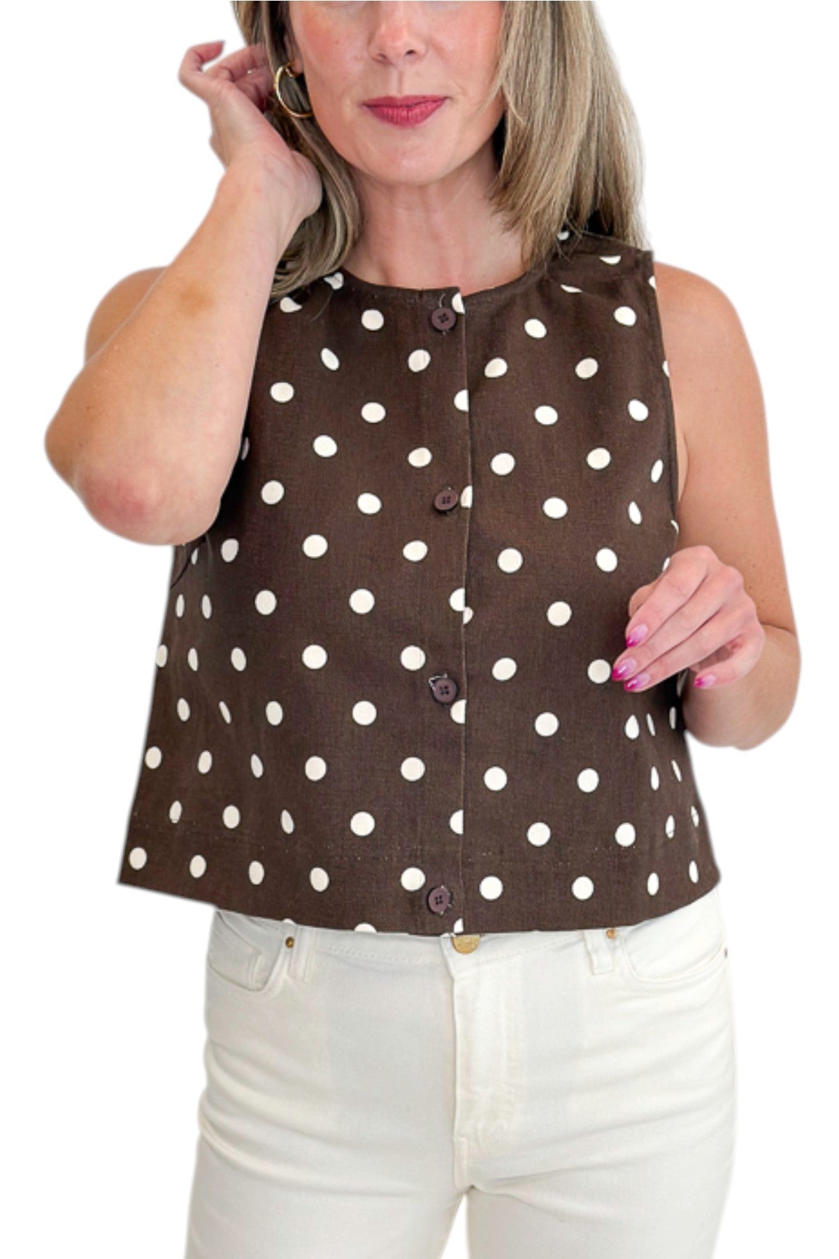 Front detail view of woman wearing Swagger Boutique’s Brown &amp; Cream Polka Dot Button Up Tank by Entro with jeans against white studio background.