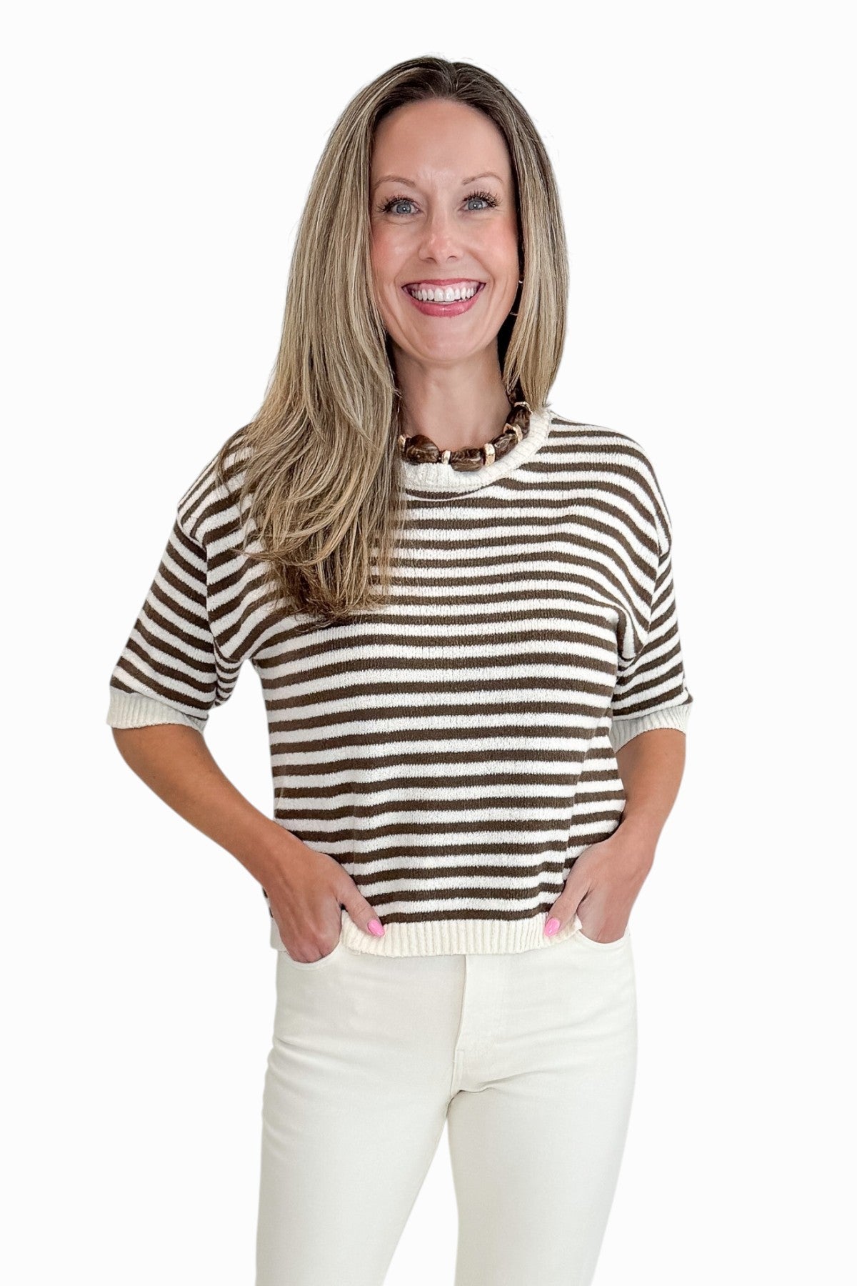 Front view of woman wearing Swagger Boutique’s Brown &amp; Cream Striped Short Sleeve Sweater with jeans against white studio background.