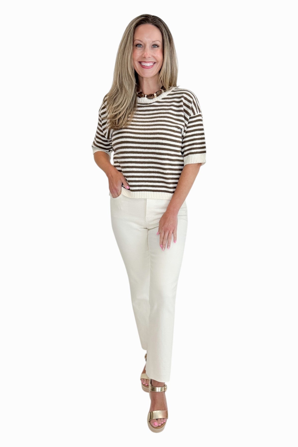 Front view of woman wearing Swagger Boutique’s Brown &amp; Cream Striped Short Sleeve Sweater with jeans against white studio background.