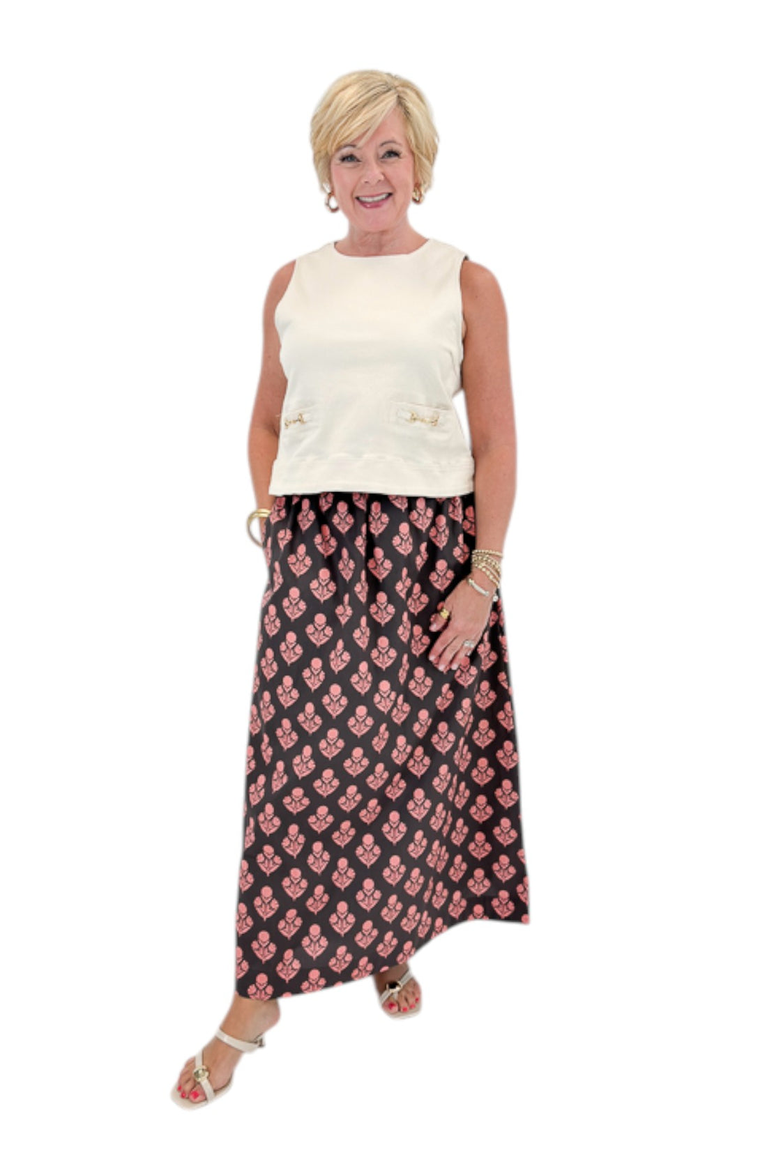 Front view of woman wearing Swagger Boutique’s Brown &amp; Pink Floral Print Skirt with top against white studio background.