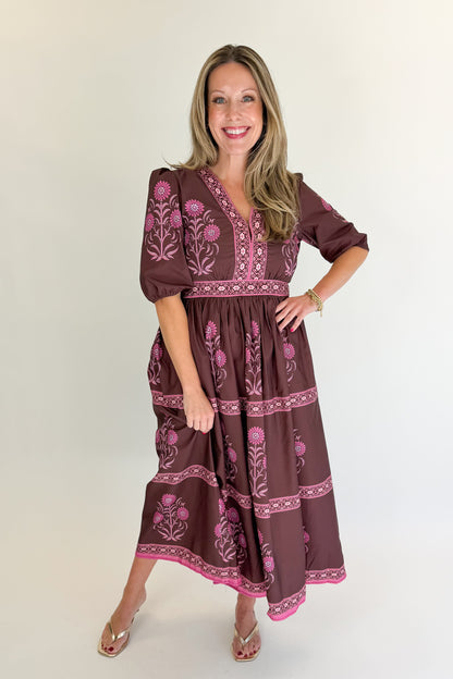 Front view of woman wearing Swagger Boutique’s Brown &amp; Pink Printed Midi Dress with heels against white studio background.