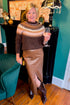 Front view of woman wearing Swagger Boutique’s Brown & Pink Fair Isle Sweater with Brown Faux Leather Slit Midi Skirt in a sitting room.