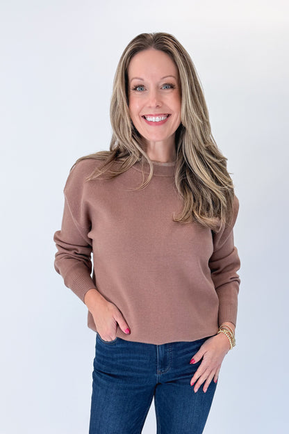 Front view of woman wearing Swagger Boutique’s Brown &amp; Taupe Double Band Sweater with jeans against white studio background.