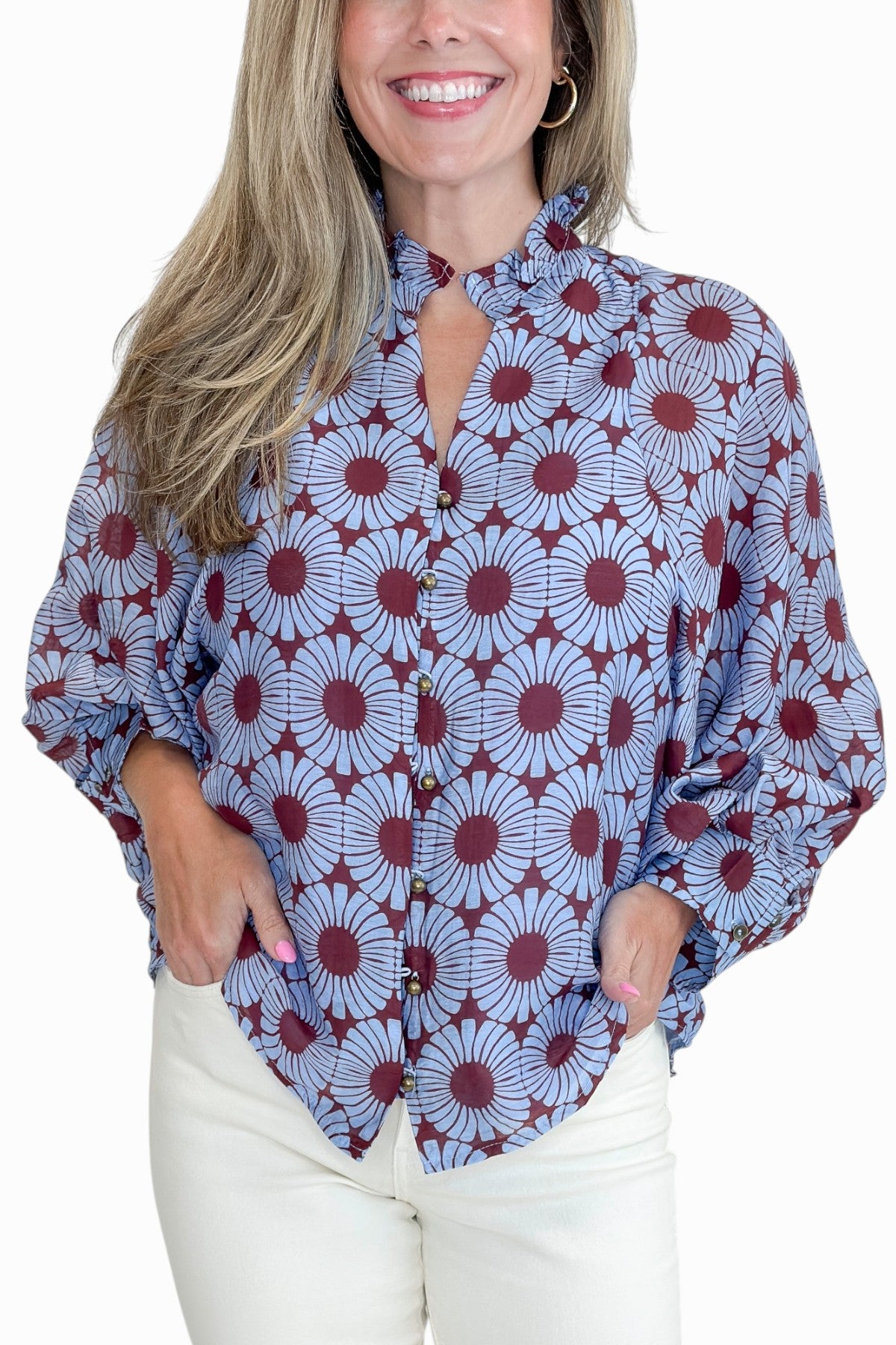 Front detail view of woman wearing Swagger Boutique’s Burgundy &amp; Blue Floral Print Long Sleeve Top by Entro with jeans against white studio background.