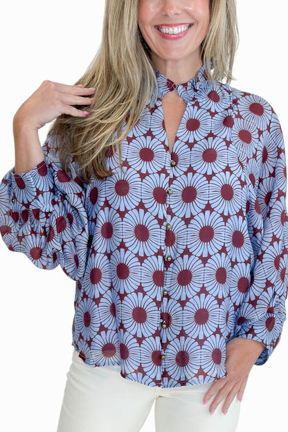 Front detail view of woman wearing Swagger Boutique’s Burgundy &amp; Blue Floral Print Long Sleeve Top by Entro with jeans against white studio background.
