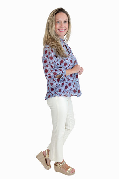 Side view of woman wearing Swagger Boutique’s Burgundy &amp; Blue Floral Print Long Sleeve Top by Entro with jeans against white studio background.