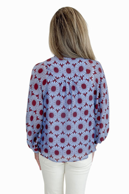 Back view of woman wearing Swagger Boutique’s Burgundy &amp; Blue Floral Print Long Sleeve Top by Entro with jeans against white studio background.