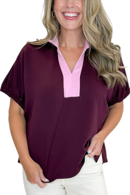 Front detail view of woman wearing Swagger Boutique’s Burgundy &amp; Pink Contrast Dolman Sleeve Top by Entro with jeans against white studio background.