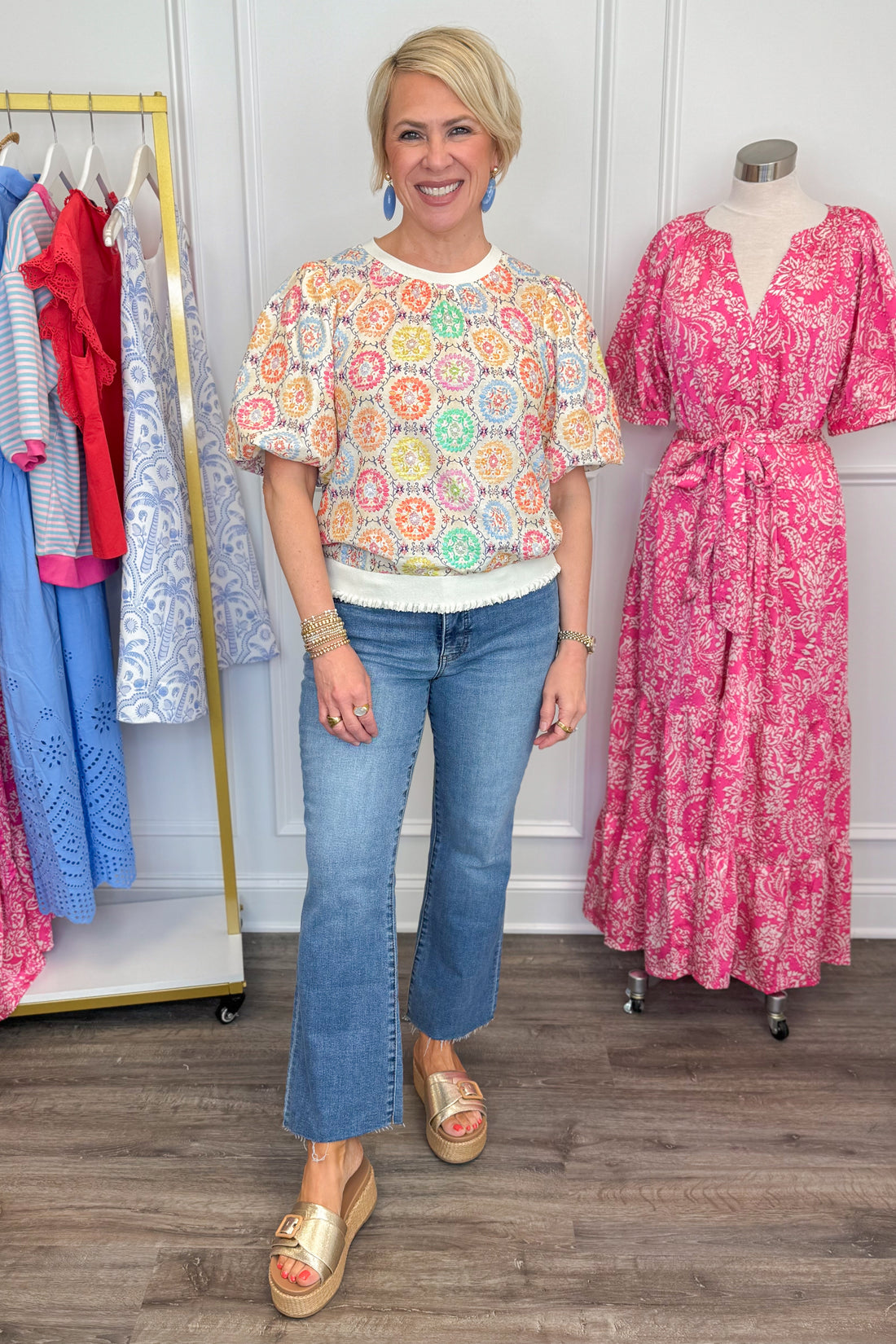 Front view of woman wearing Multi Circle &amp; Floral Print Top with jeans and sandals.