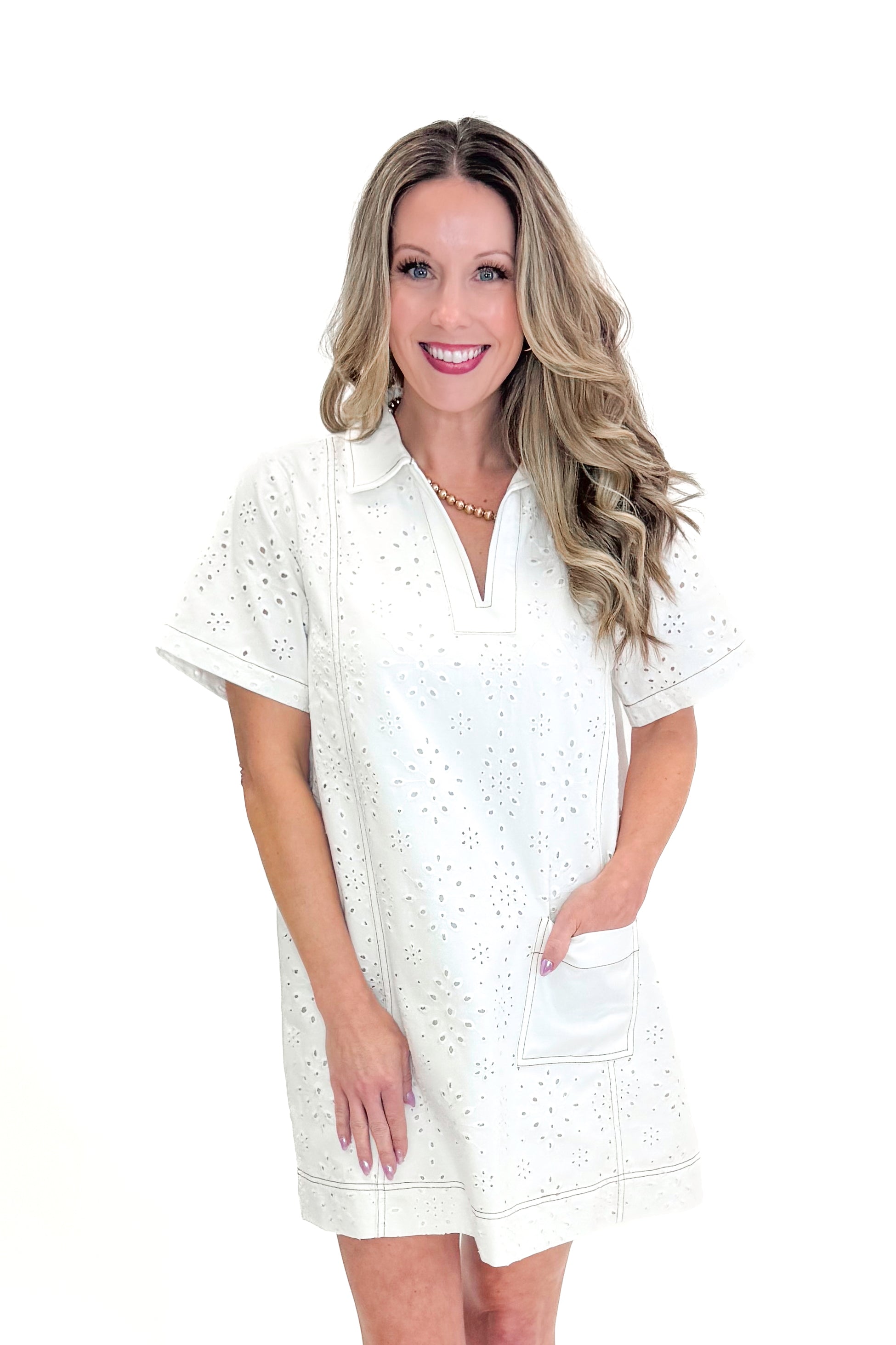 Front view of woman wearing Cream Eyelet Pocket Detail Dress with sandals against white studio background.