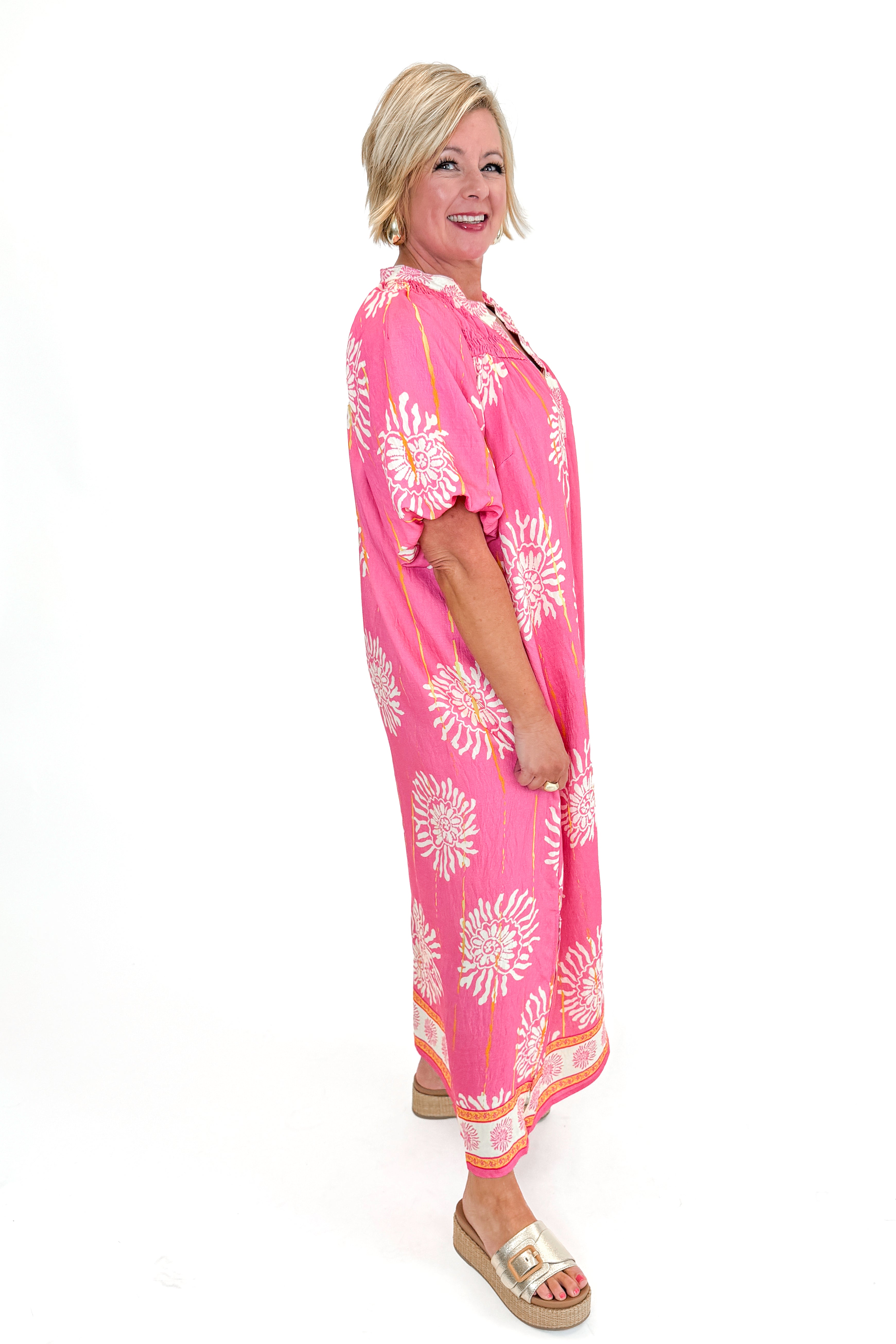 Side view of woman wearing Pink Printed Midi Dress against white studio background.