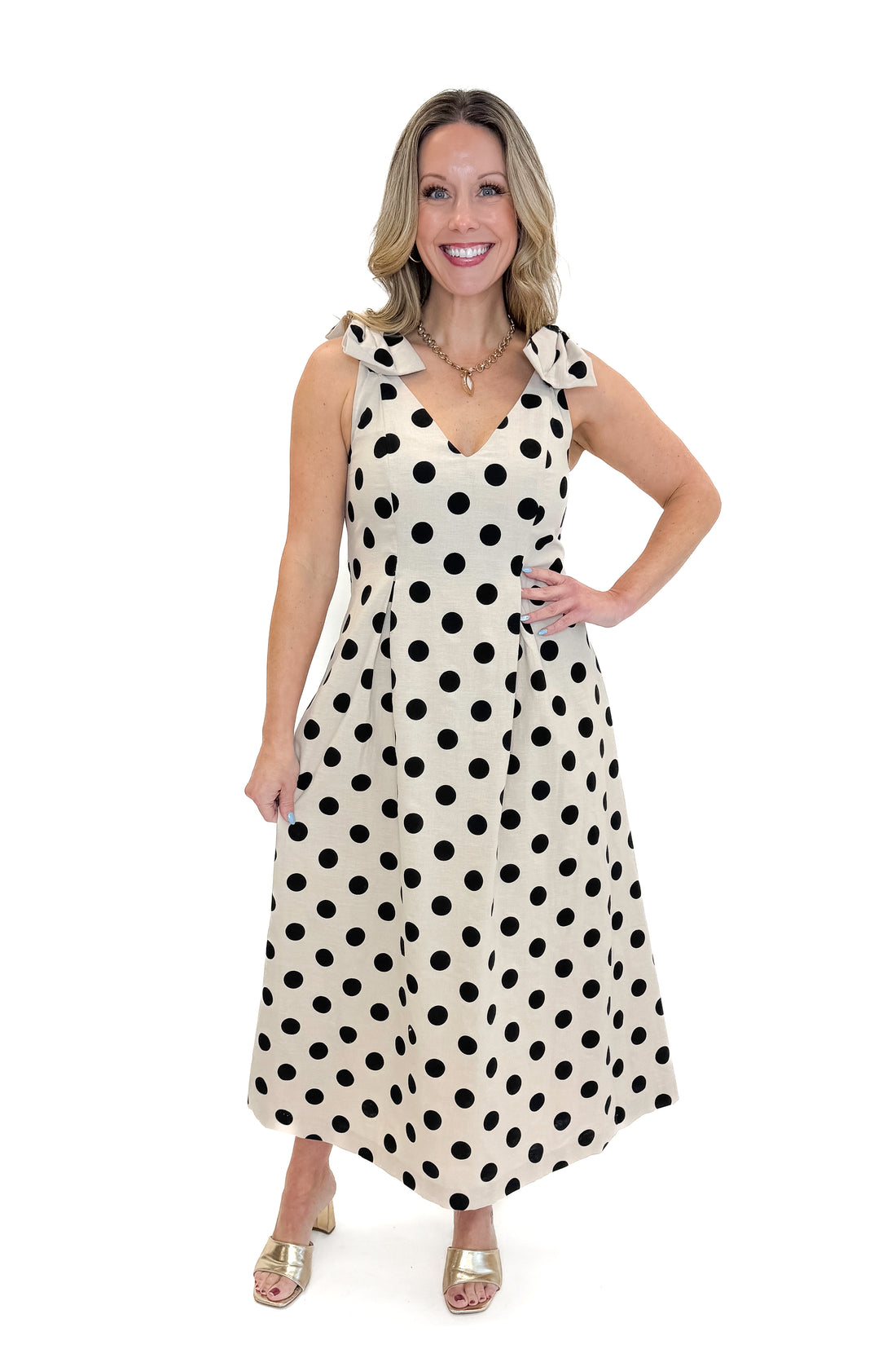 Front view of woman wearing Linen Polka Dot Pleat Detail Midi Dress against white studio background.