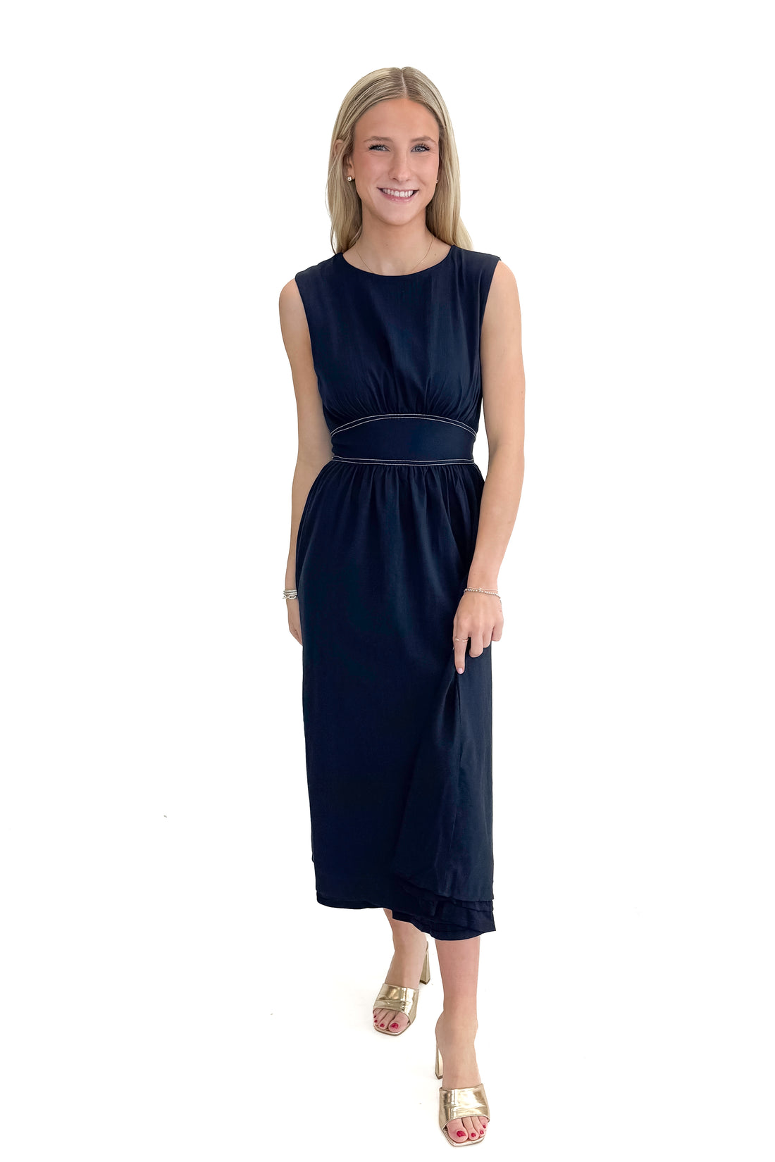Front view of woman wearing Navy Stitch Waist Mid Dress against white studio background.