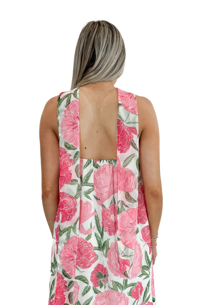 Back view of woman wearing Pink Floral Maxi Dress With Convertible Scarf against white studio background.