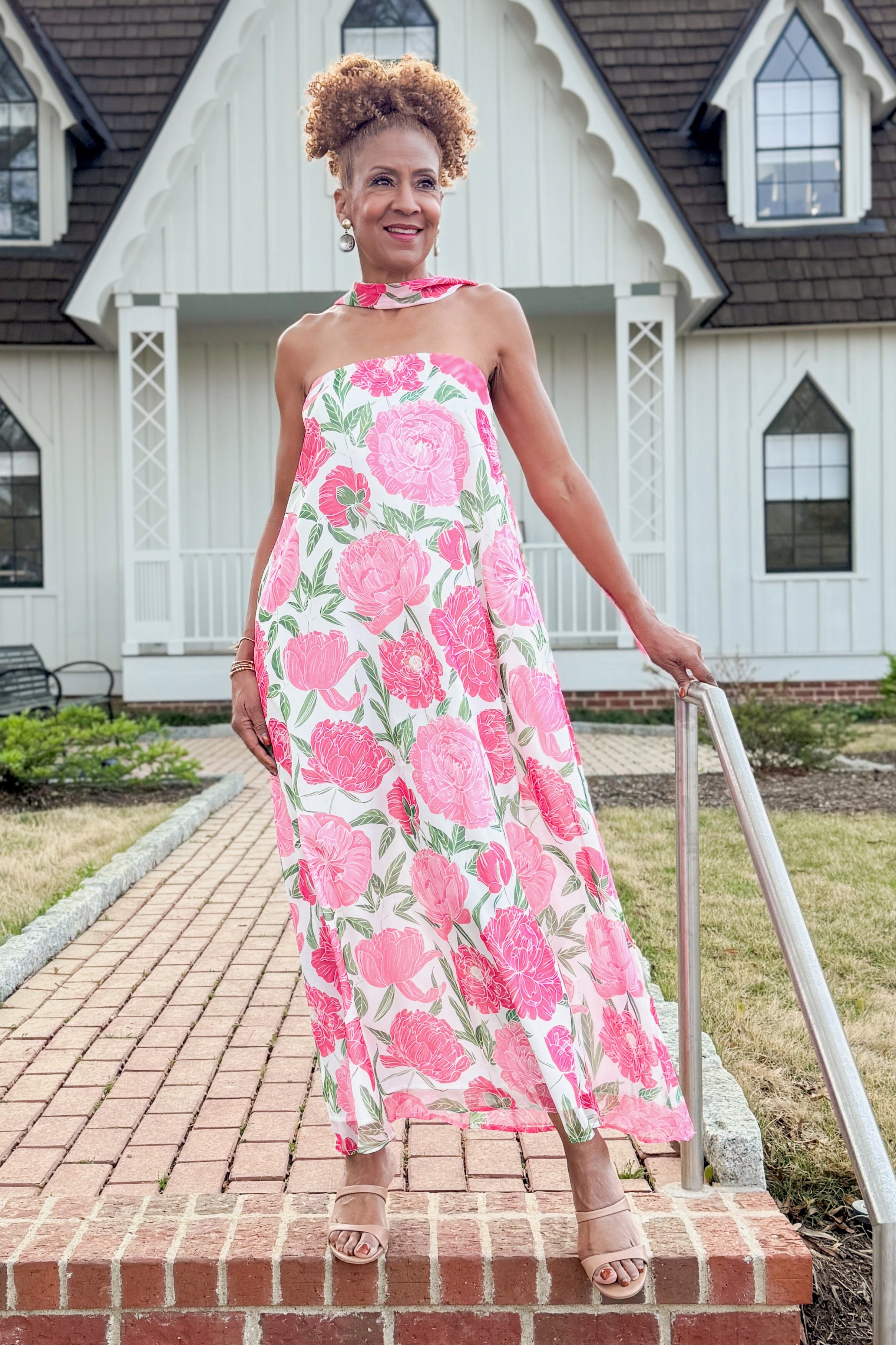 Front view of woman wearing Pink Floral Maxi Dress With Convertible Scarf walking outside.