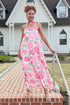 Front view of woman wearing Pink Floral Maxi Dress With Convertible Scarf walking outside.