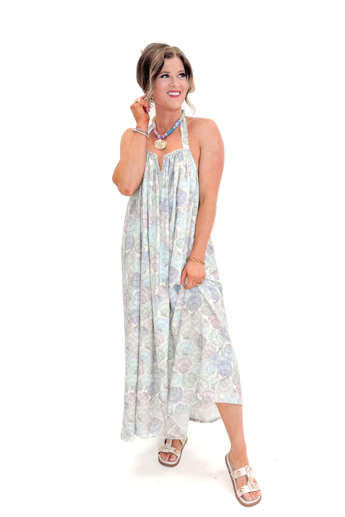Front view of woman wearing Blue &amp; Multi Shell Print Halter Neck Dress with sandals against white studio background.