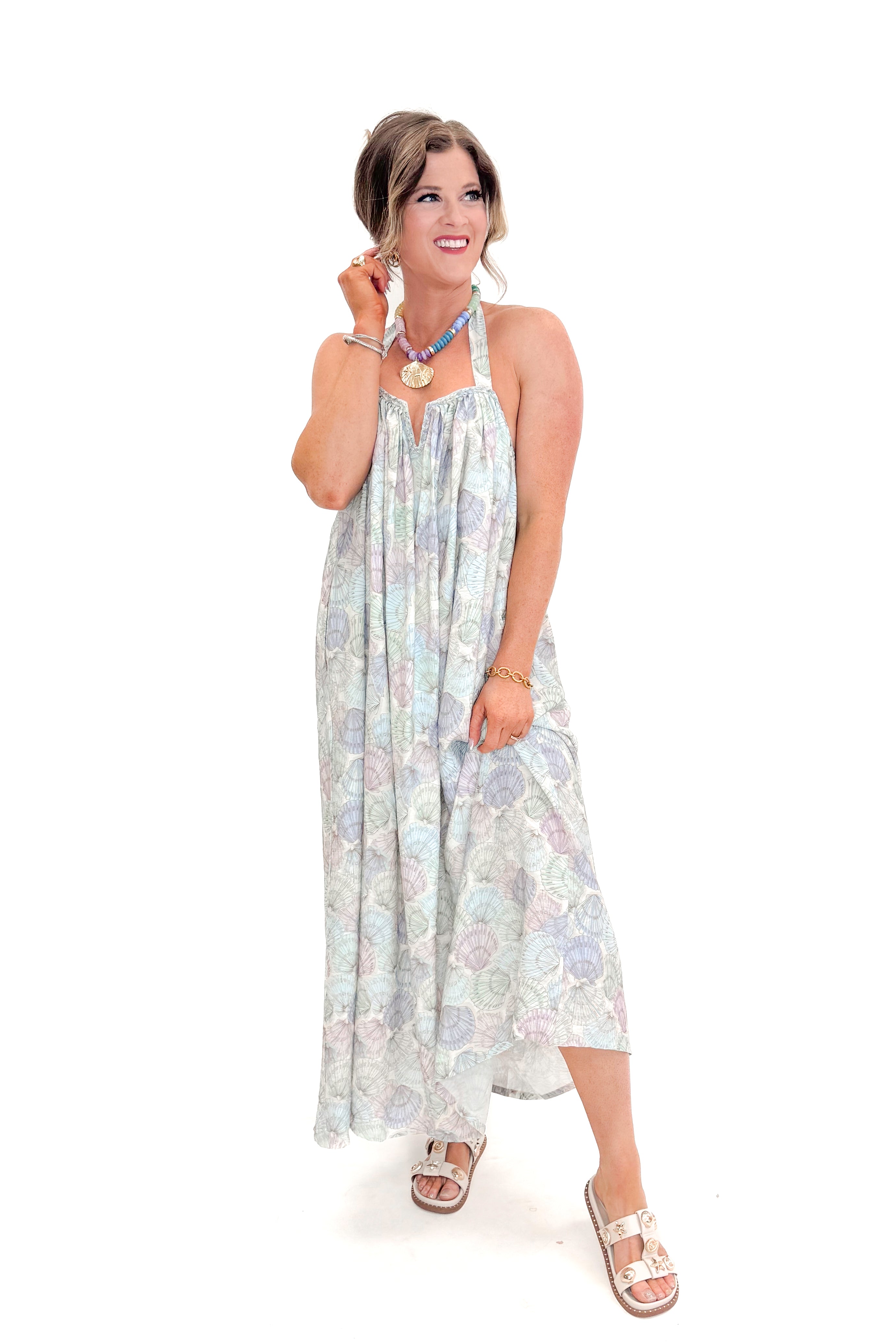 Front view of woman wearing Blue &amp; Multi Shell Print Halter Neck Dress with sandals against white studio background.