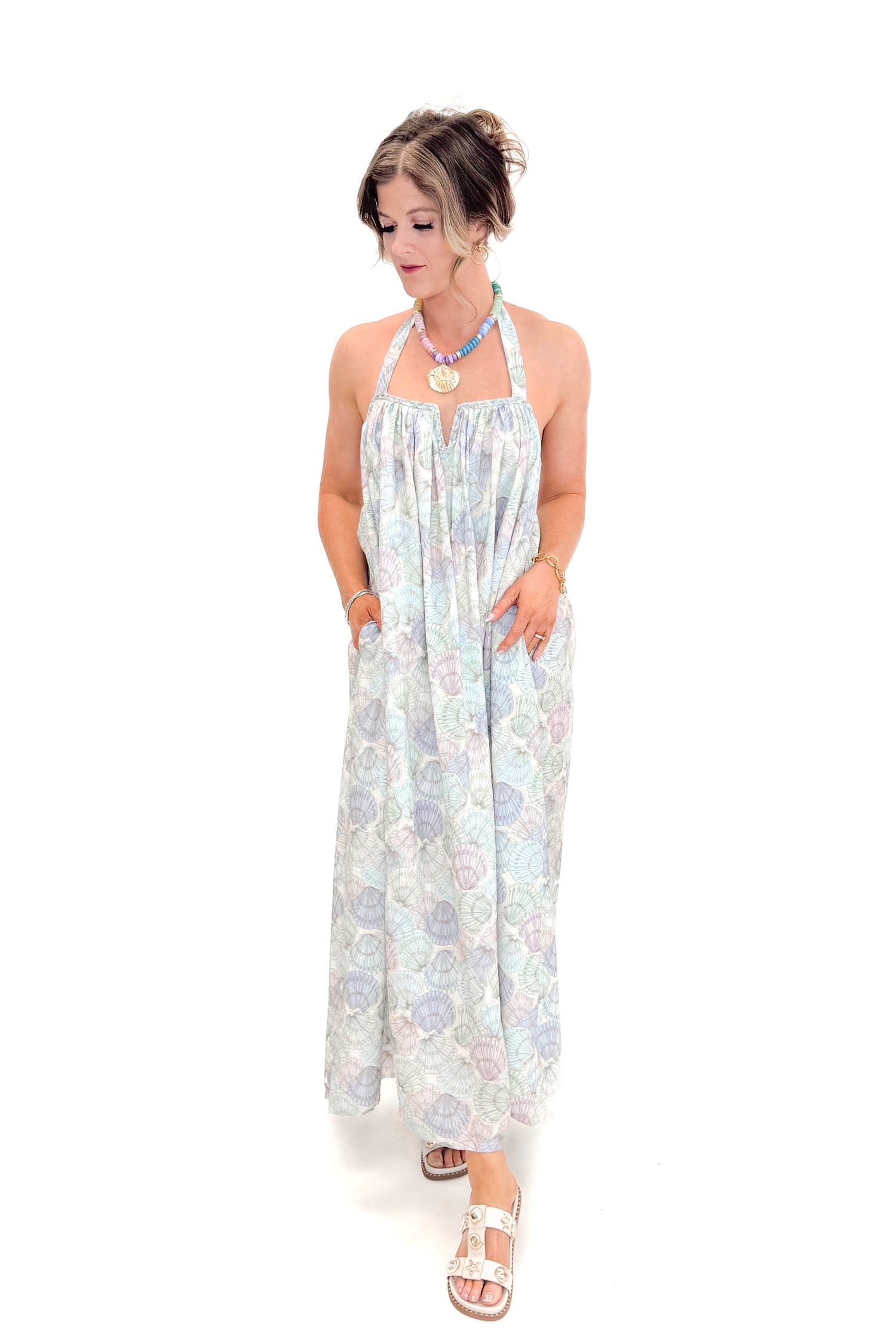 Front view of woman wearing Blue &amp; Multi Shell Print Halter Neck Dress with sandals against white studio background.
