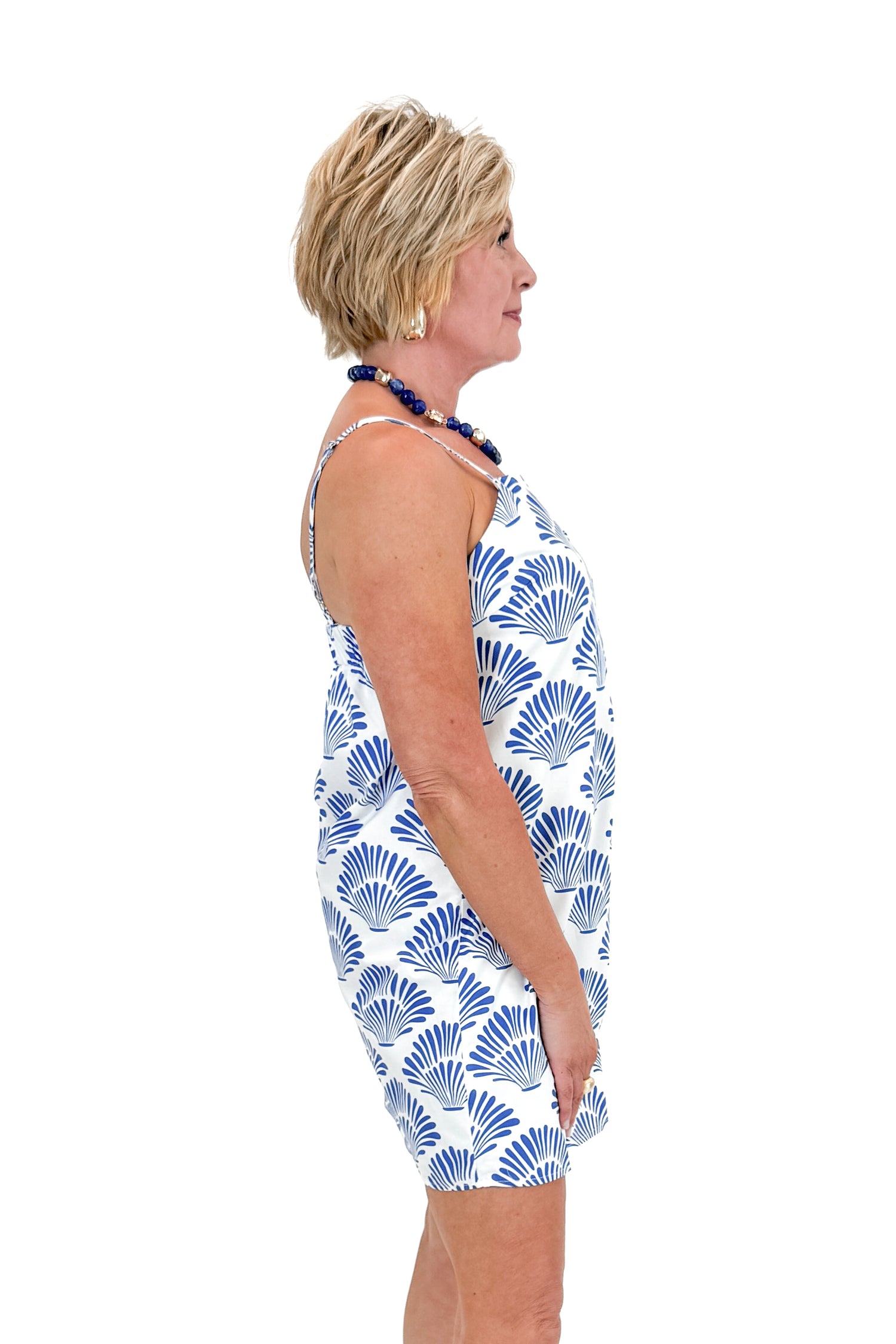 Side view of woman wearing Blue Shell Print Scallop Detail Dress against white studio background.