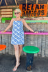 Front view of woman wearing Blue Shell Print Scallop Detail Dress at an outside bar.