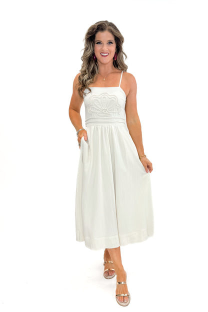 Front view of woman wearing Cream Shell Embroidered Midi Dress by TCEC with gold bar sandals against white studio background.