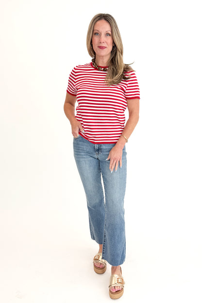 Front view of woman wearing Red &amp; White Striped Short Sleeve Sweater with jeans against white studio background.