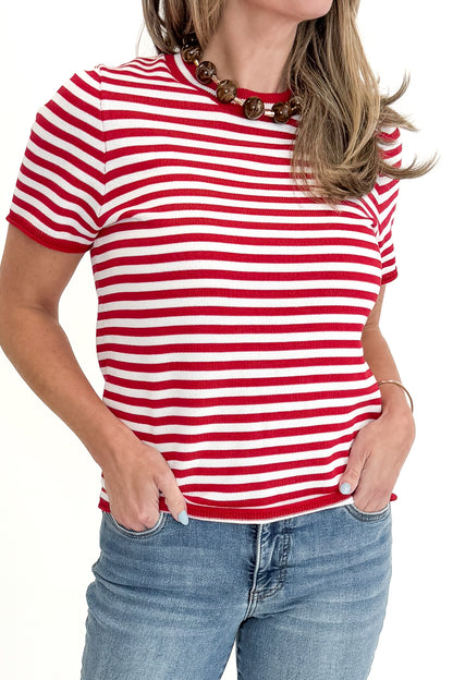 Front detail view of woman wearing Red &amp; White Striped Short Sleeve Sweater with jeans against white studio background.