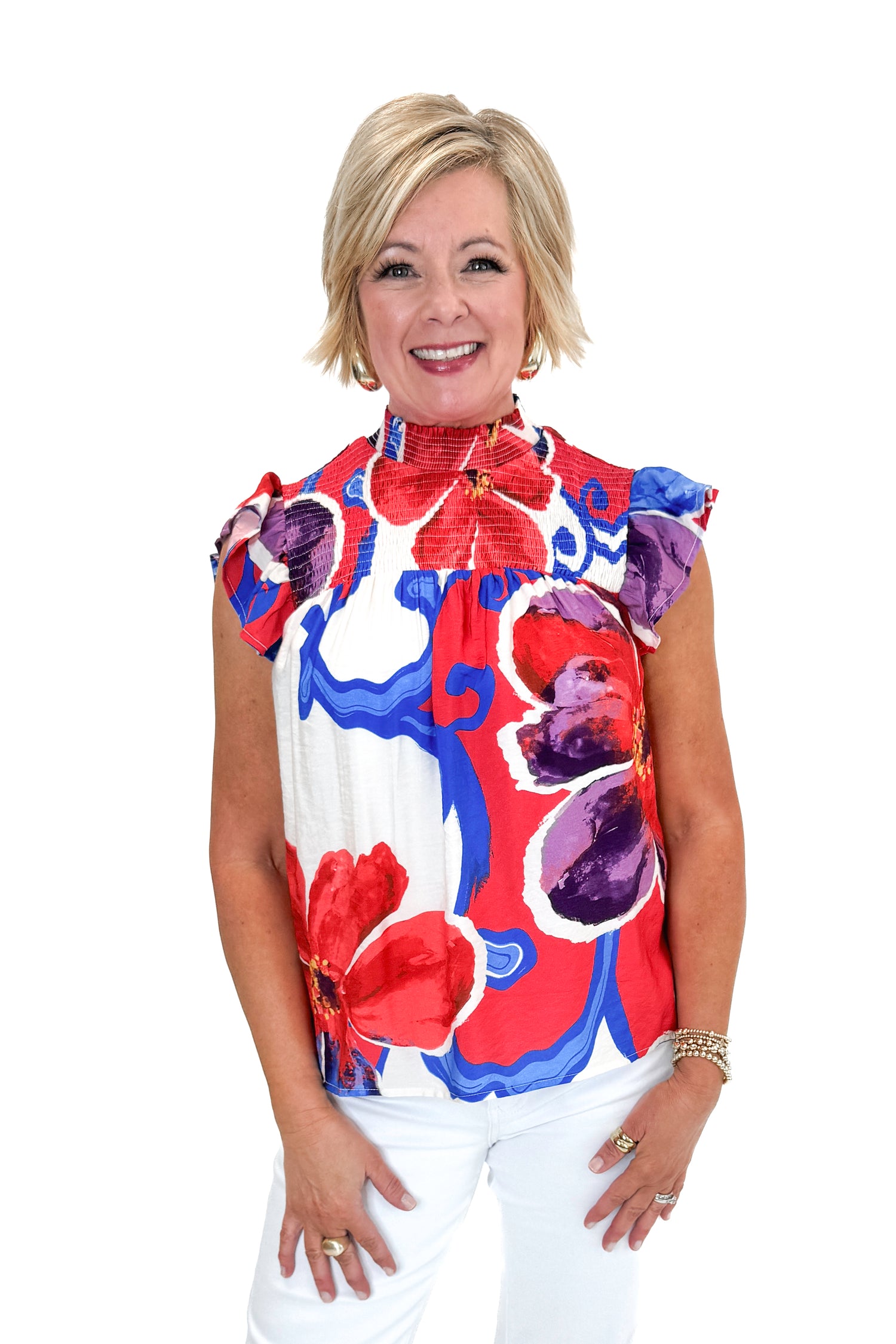 Front view of woman wearing Multi Floral Smocked Detail Top with jeans against white studio background.