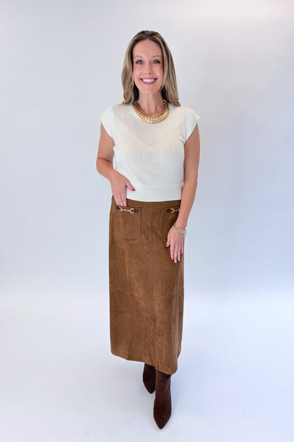 Front view of woman wearing Swagger Boutique’s White Cap Sleeve Sweater by PINCH with Camel Suede Midi Skirt With Pockets by Entro against white studio background.