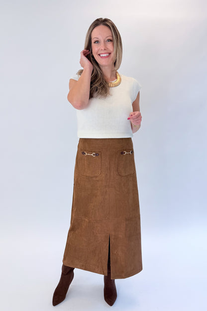 Front view of woman wearing Swagger Boutique’s White Cap Sleeve Sweater by PINCH with Camel Suede Midi Skirt With Pockets by Entro against white studio background.