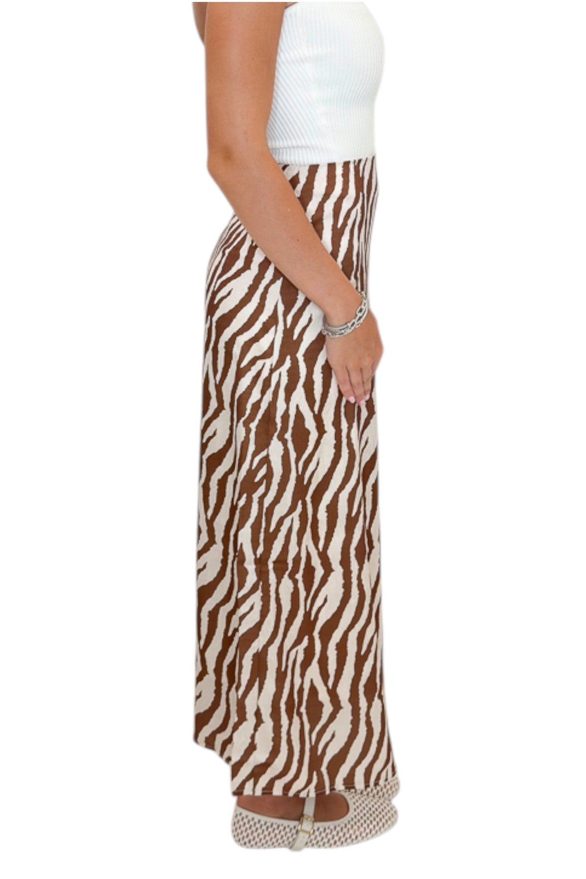 Side view of woman wearing Swagger Boutique’s Camel Zebra Print Midi Skirt against white studio background.