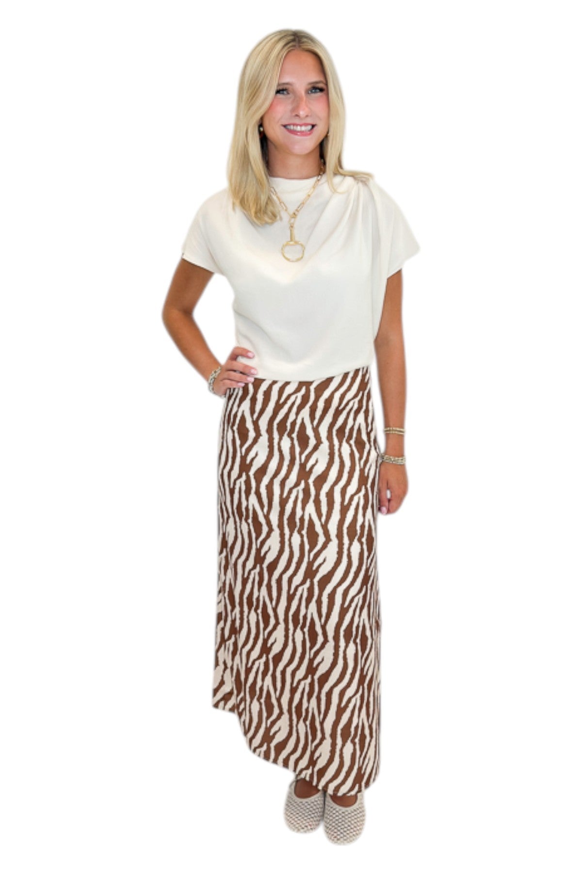 Front view of woman wearing Swagger Boutique’s Cream Cowl Neck Top with Camel Zebra Print Midi Skirt against white studio background.