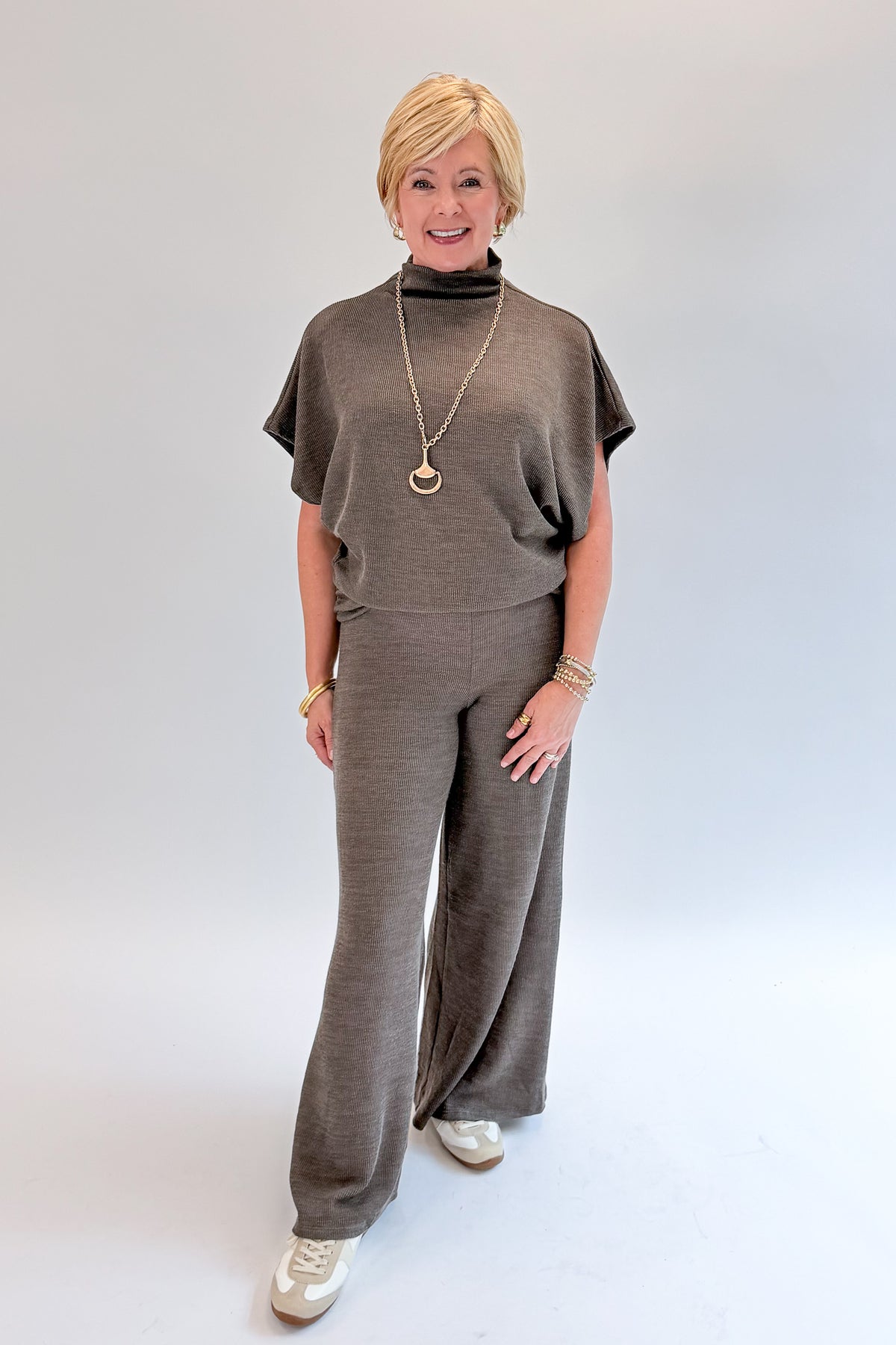 Front view of woman wearing Swagger Boutique’s Charcoal Ribbed Short Sleeve Turtleneck Top &amp; Lounge Pants against white studio background.