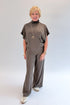 Front view of woman wearing Swagger Boutique’s Charcoal Ribbed Short Sleeve Turtleneck Top & Lounge Pants against white studio background.