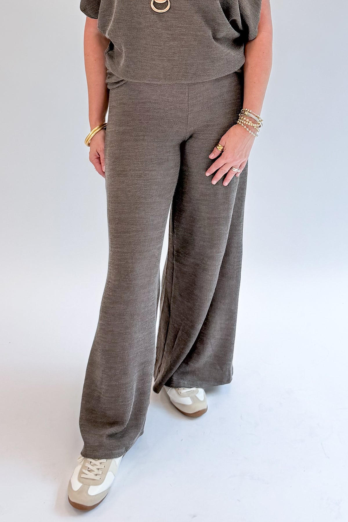 Front detail view of woman wearing Swagger Boutique’s Charcoal Ribbed Short Sleeve Turtleneck Top &amp; Lounge Pants against white studio background.