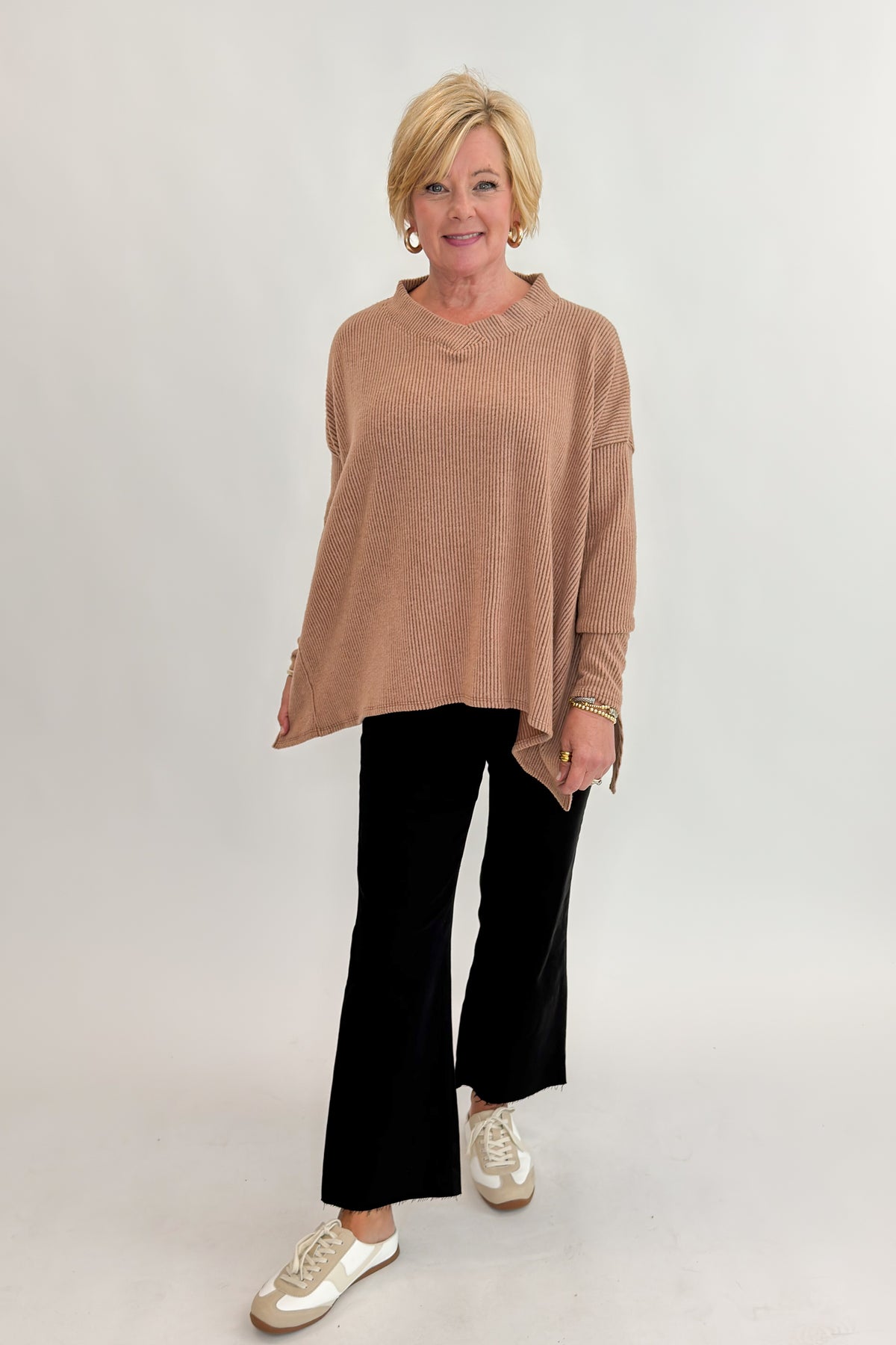 Front view of woman wearing Swagger Boutique’s Chestnut Brushed V-neck Top with jeans against white studio background.