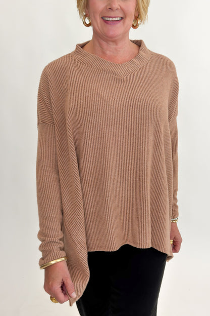 Front detail view of woman wearing Swagger Boutique’s Chestnut Brushed V-neck Top with jeans against white studio background.