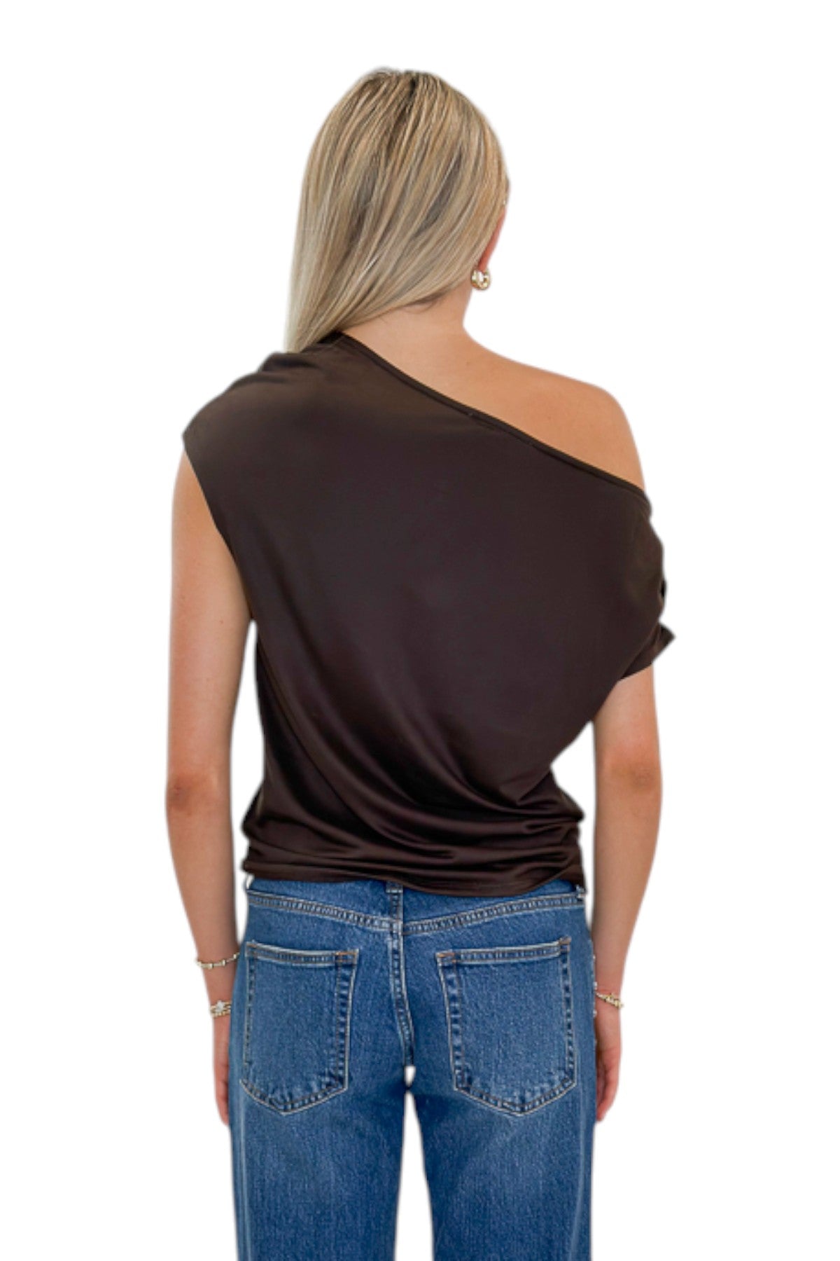 Back view of woman wearing Swagger Boutique’s Chocolate Brown Off The Shoulder Top with jeans against white studio background.