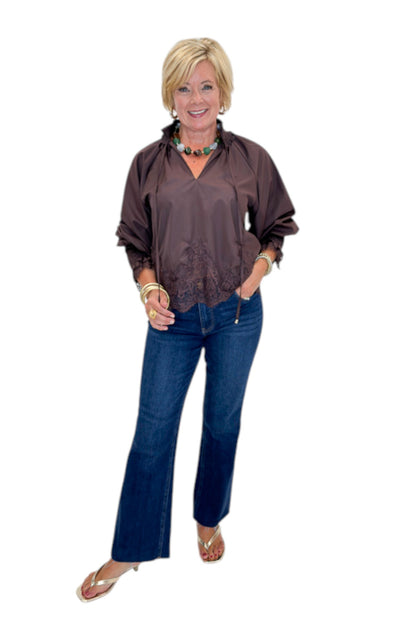 Front view of woman wearing Swagger Boutique’s Chocolate Lace Lined Top by Entro with jeans against white studio background.