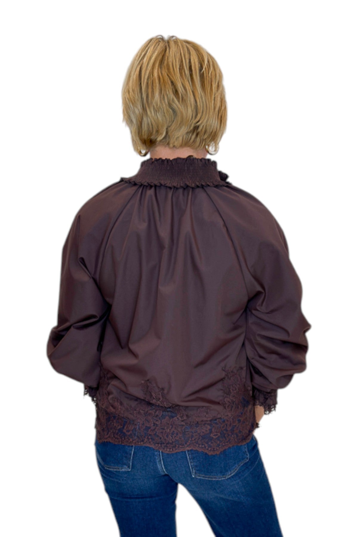 Back view of woman wearing Swagger Boutique’s Chocolate Lace Lined Top by Entro with jeans against white studio background.
