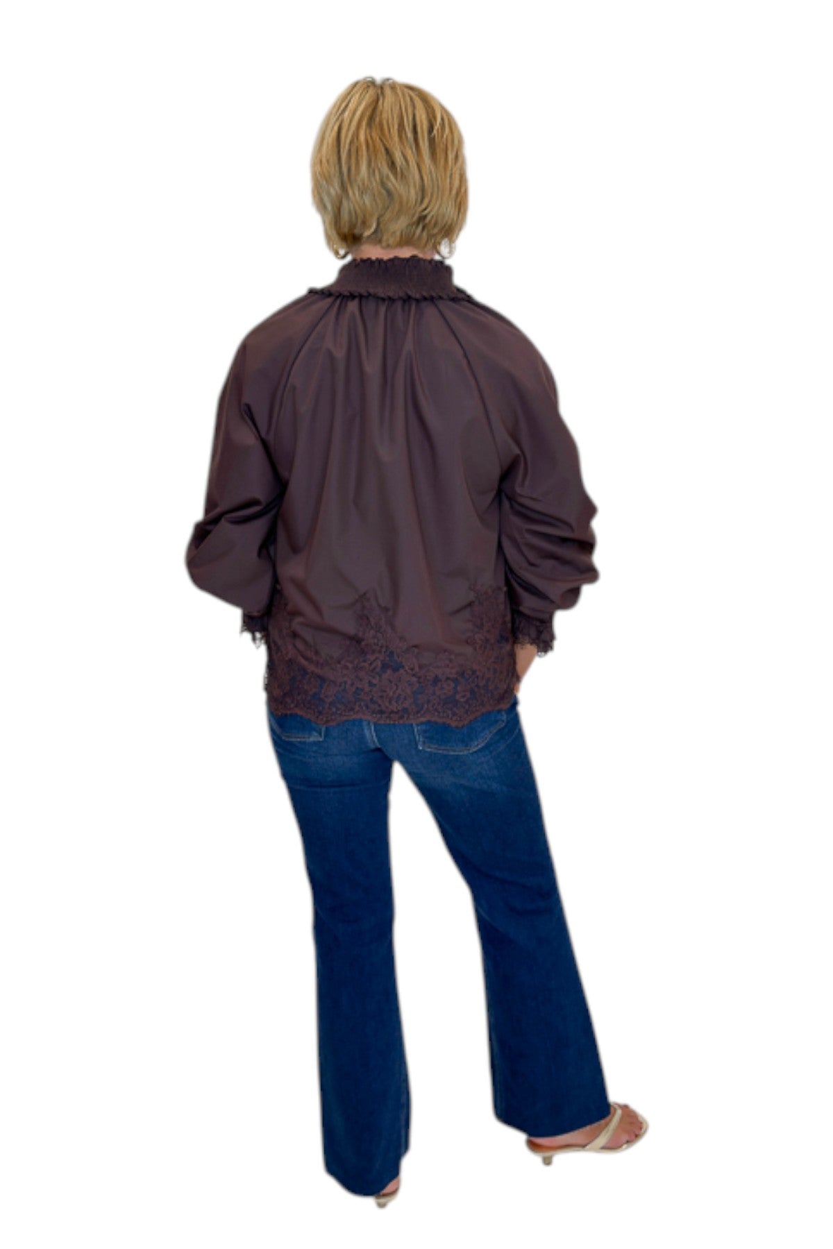 Back view of woman wearing Swagger Boutique’s Chocolate Lace Lined Top by Entro with jeans against white studio background.
