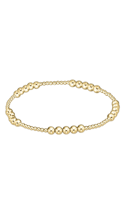 Gold bracelet on a plain white background