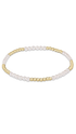 A delicate beaded stretch bracelet featuring alternating strands of pearls and polished yellow gold beads, displayed on a clean white background.