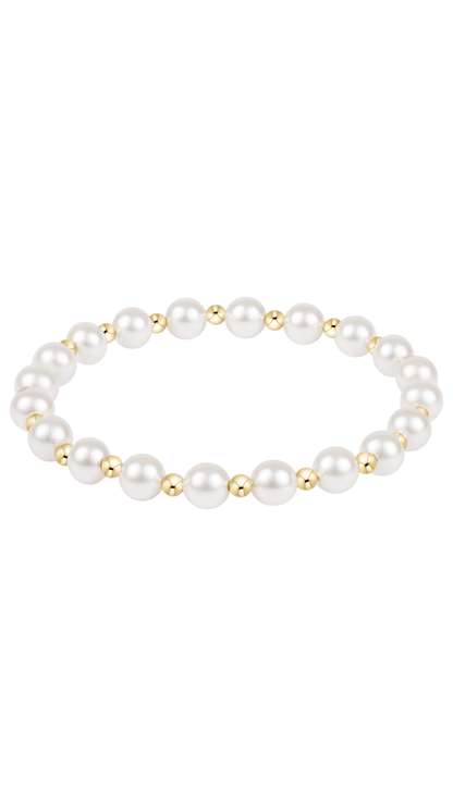 A stretch bracelet featuring pearls and small gold beads, displayed against a solid white background.