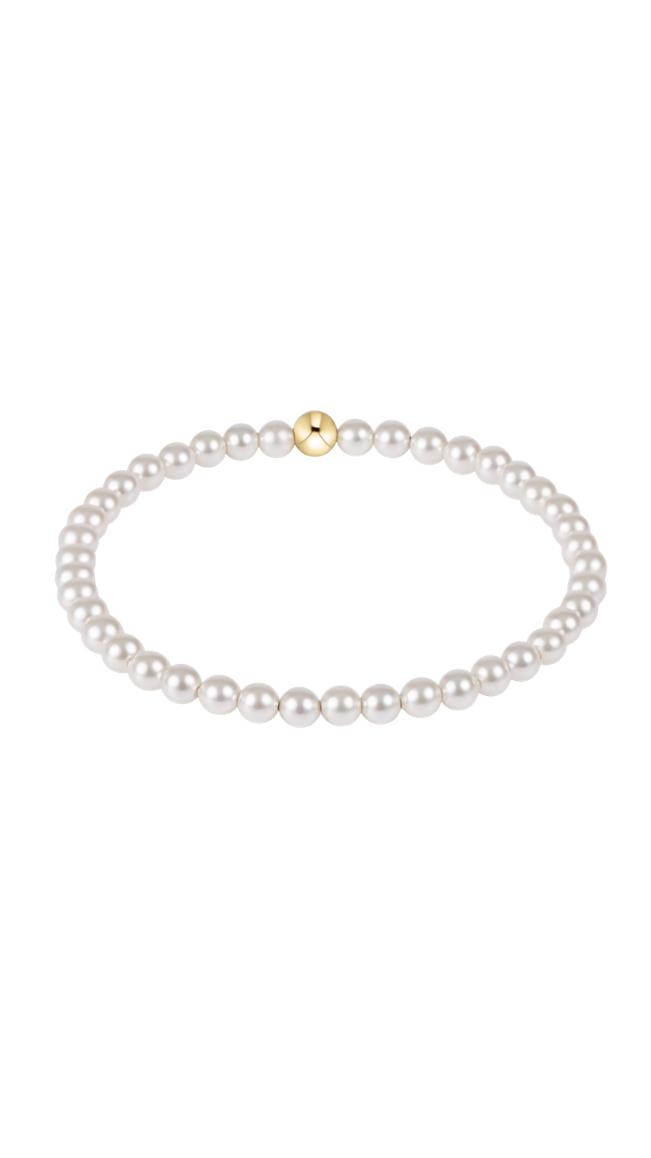 Pearl bracelet with a gold bead on a white background