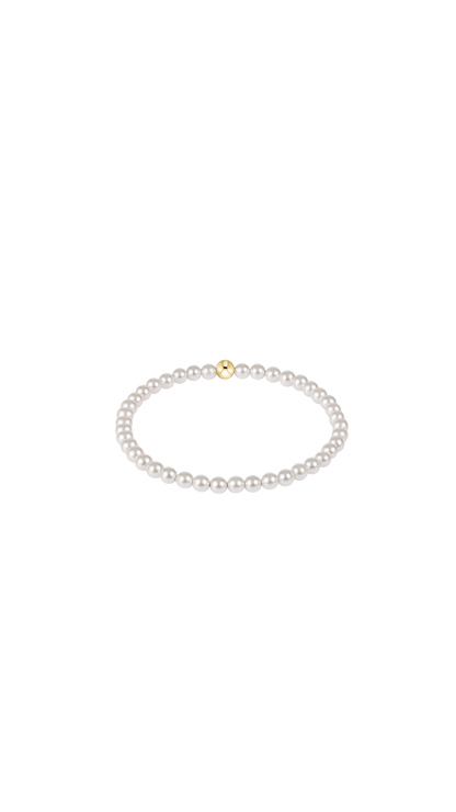 Pearl bracelet with a gold bead on a white background