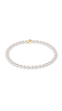 Pearl bracelet with a gold bead on a white background